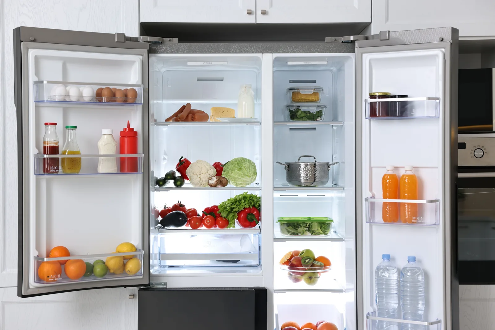 Fridge-freezer packed with fresh and frozen food, cooling reliably